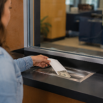 Cliente realizando um depósito em dinheiro em uma conta bancária em uma instituição financeira nos Estados Unidos.